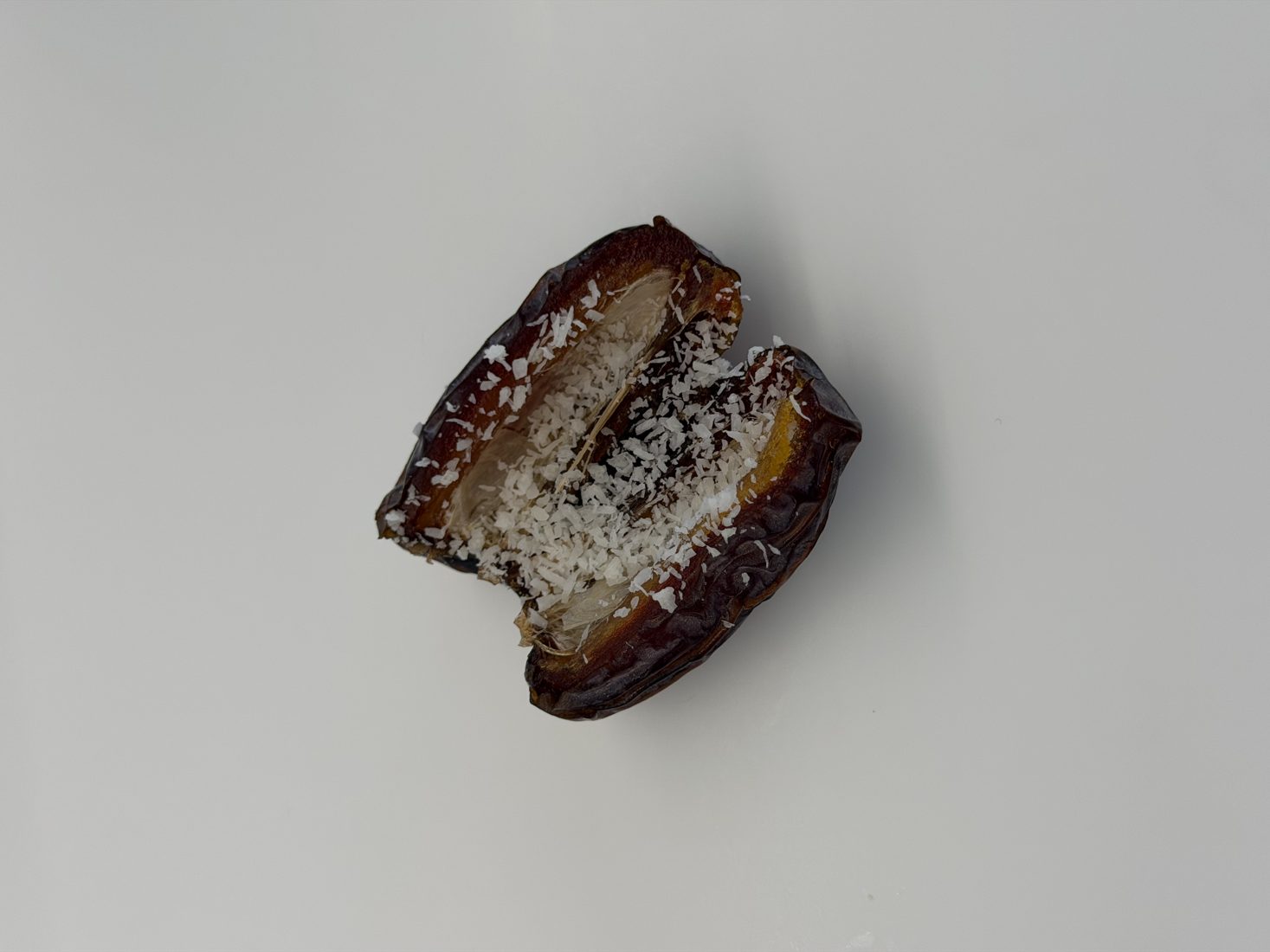 Medjool date with shredded coconut — a simple whole-food sweet