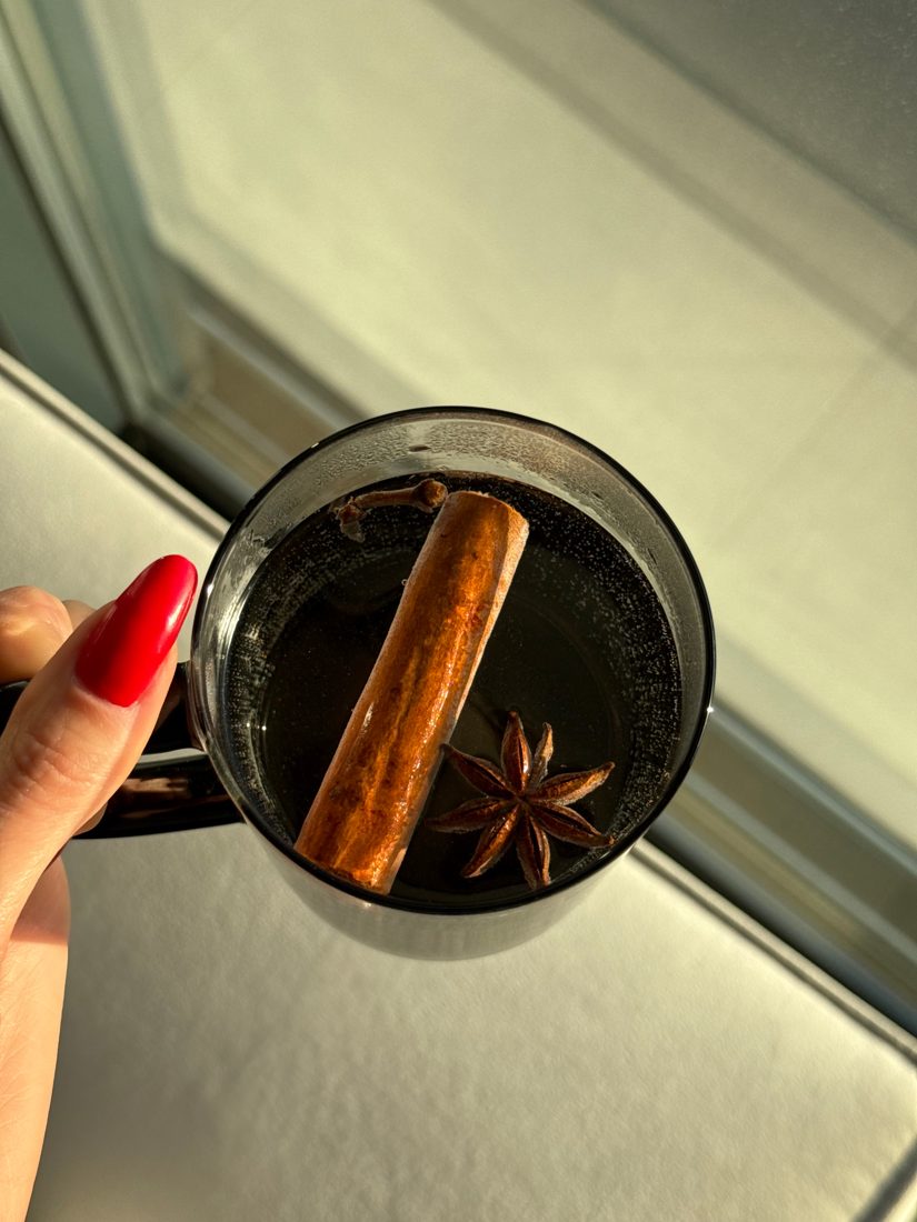 Warm spiced tea with cinnamon and star anise in morning light